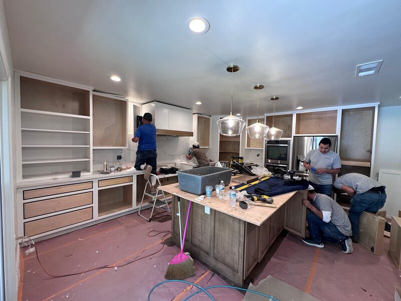 Crew on site framing the kitchen island under construction.